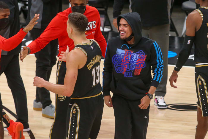 Atlanta Hawks guard Trae Young (11) celebrates with guard Bogdan Bogdanovic (13) during a timeout against the Milwaukee Bucks in the third quarter during game four of the Eastern Conference Finals for the 2021 NBA Playoffs at State Farm Arena.